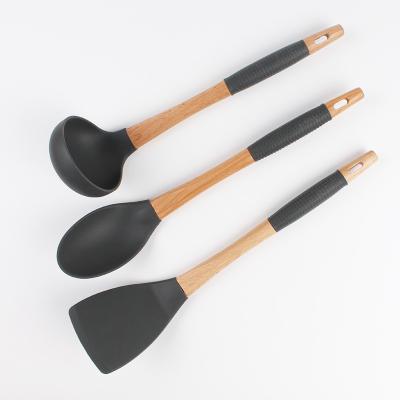 China Sustainable Kitchenware Food Grade Custom Silicone With Handle Wooden Soup Pouch Turner Shovel Kitchen Utensils for sale