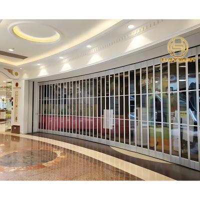 China Polycarbonate Anti-theft Aluminum Frame Commercial Sliding Folding Door for sale