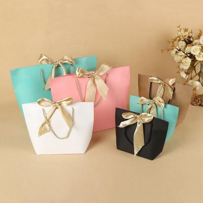 China Recycled Materials Customized Brand Logo Luxury Kraft Paper Bag Packaging Paper Bags For Clothes for sale