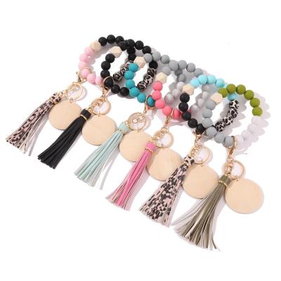 China New 2021 fashionable keychain decoration color key chain wooden wooden bead bracelet bead jewelry accessories bracelet key chain for sale