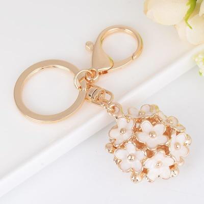 China Promotional Gift Lilangda Rhinestone Dripping Oil Flower Key Chain Female Backpack Jewelry Lady Couple Bag Fashion Key Chain Flowers Metal for sale