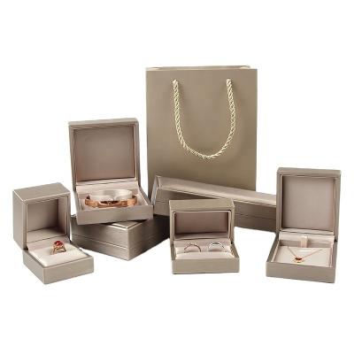 China PU Plastic Jewelry Accessories Premium Leather Storage Box for Ring Necklace Bracelet Pendant for sale