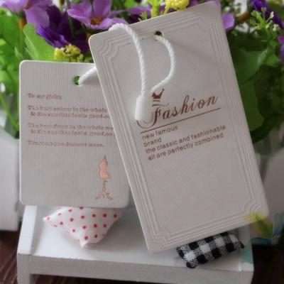 China Sustainable Luxury Custom Printed Clothing Swing Paper Label Hang Tag for sale