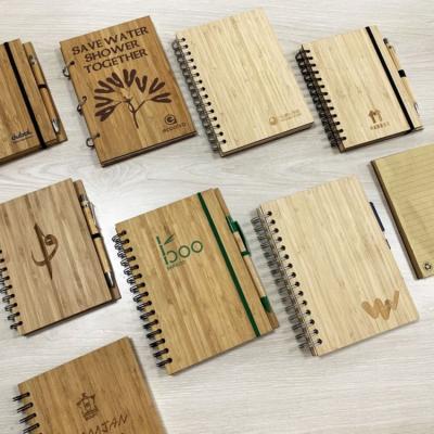 China Eco-friendly Recycled Bamboo Spiral Cover Kraft Paper Spiral Notebook With Pen for sale