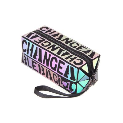 China Custom Wholesale Luminous Clutch Wristband Triangle Bag Logo PU Geometric Luminous Makeup Cosmetic Bag for sale