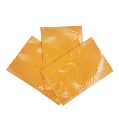 China Aluminium Foil Laminated Glossy Orange Color Custom Flat Pouches for Face Mask Sheet, Facial Cream Packaging for sale