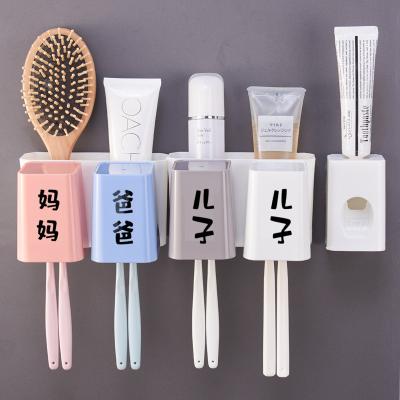 China Sustainable Automatic Toothpaste Dispenser Black Wall Mounted Plastic Toothbrush Holder With Transparent Square Tooth Brushing Cups for sale