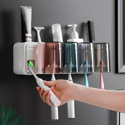 China Eco-friendly Multifunctional Wall Mounted Toothbrush Holder Set Toothpaste Dispenser With Round Brushing Cup For Bathroom for sale