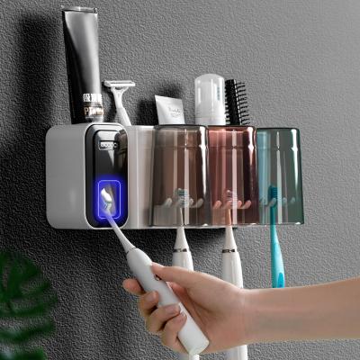 China Sustainable modern bathroom accessory set wall mounted toothpaste dispenser and toothbrush holder with toothbrush cups for sale