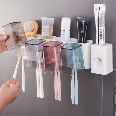 China Sustainable Wall Mounted Toothpaste Vending Machine With Toothbrush Holders Set Dustproof Toiletries Set For Household Bathroom for sale