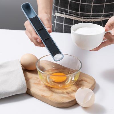 China Viable the most popular double head measuring scale plastic adjustable spoon for kitchen cooking instrument for sale