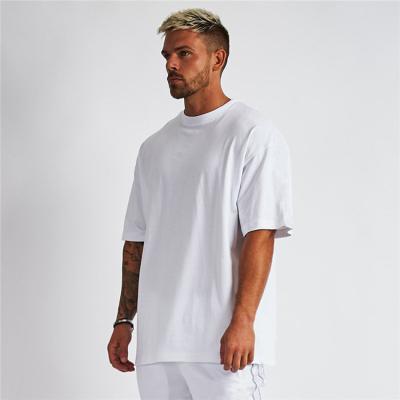 China Anti-wrinkle Men's Plus Size Solid Color White Bodybuilding Loose Fitness Short Sleeve T-Shirt for sale