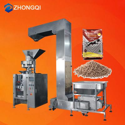 China Automatic Weighing Food Pet Food Granules Vacuum Pack Large Package Fish Feed Packing Machine With Conveyor for sale