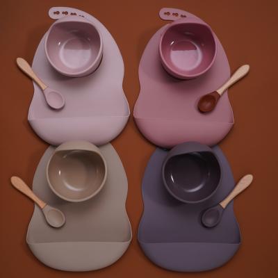 China Minimalist Silicone BPA Free Safe Waterproof Baby Bib Kids Toddler Feeding Sucker Bowl and Wooden Silicone Baby Spoon Handle Feeding Set for sale