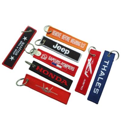 China Classic Cloth Woven Key Chain With Logo Single /double Sides Embroidery Custom Apparel Woven Key Chain for sale