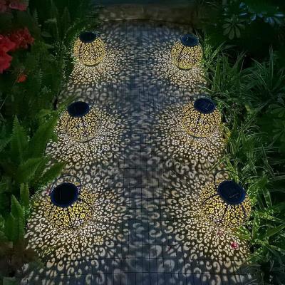 China Eco-friendly Metal Solar Outdoor Waterproof Hollow Lantern Light Decoration LED Solar Christmas Light Garden Projection Lantern for sale