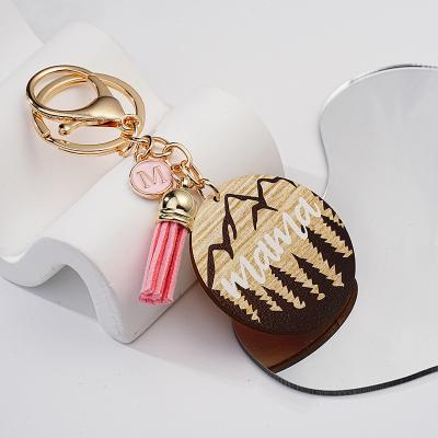 China Durable New Mother's Day Round Wood Tassel High Mountain Forest protection key chains for sale