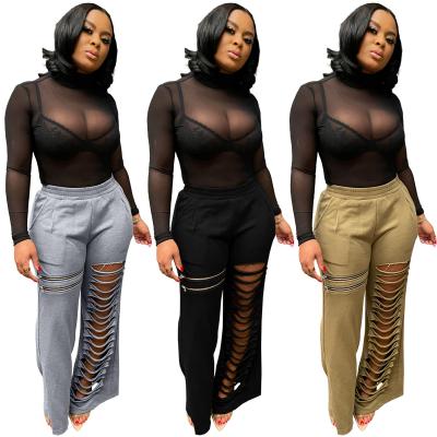 China 2022 QUICK DRY solid hollow out casual pants fashion zipper hole flare pants for ladies à venda