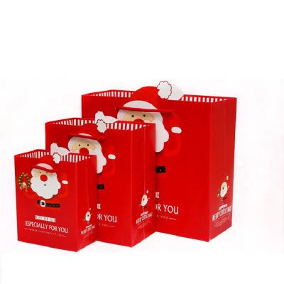 China Merry Christmas Cute Recyclable Wholesale Customized Cardboard Holiday White Paper Gift Bag For Party Favor for sale