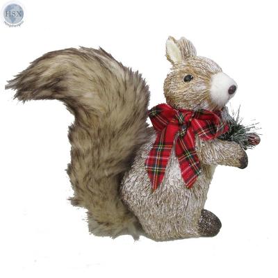 China Traditional indoor Christmas handcrafted grass squirrel with fur tail and red and green plaid bow tie with pine tree in hand for sale