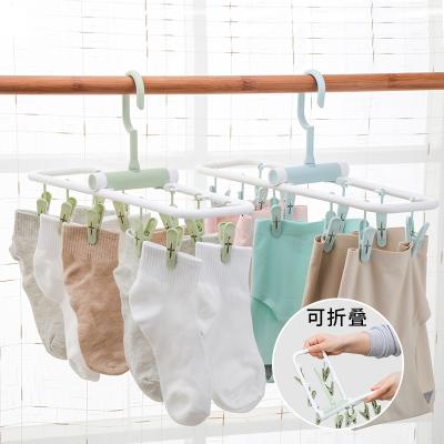 China Traditional Cheapest Plastic Clothes Hanger Single Collapsible Laundry Hanger Rack With 10 Piece Pegs for sale