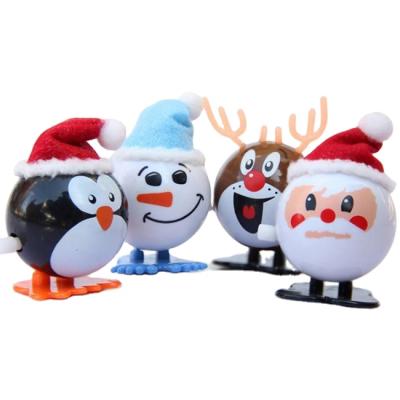 China BSCI Christmas Mini Plastic Jumping Santa Claus Gift Roll Up Toys For Children for sale