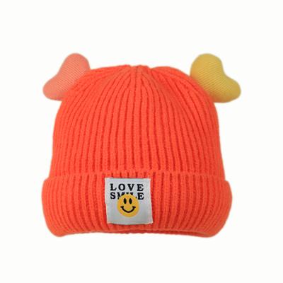 China JOINT Custom Cute Newborn Warm Children Heart Ears Baby Smiling Label Knit Beanies Hats for sale