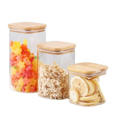 China Sustainable Factory Price Storage Food Square Transparent Glass Jar With Wooden Lid for sale