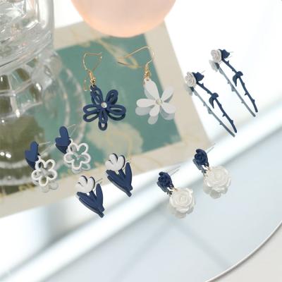 China Design Daisy Rose Fashion Earrings High Quality Silver Needle Crossing Design New Flower Color Cool Blue White Asymmetrical Hollow Hook Earrings for sale