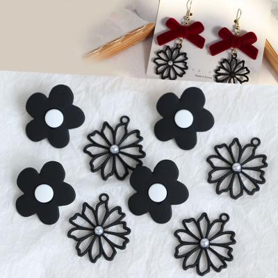 China Wholesale Cool Black Color Daisy Flower Alloy Spray Paint Charms Earrings Studs Hollow Flower Metal Pendants DIY Jewelry Suppliers for sale