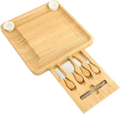 China Sustainable Wholesale Cheese Board and Knife Set Bamboo Charcuterie Board with Magnetic Slide-out Drawer and 2 Ceramic Bowls for sale