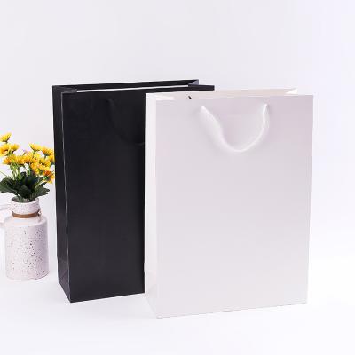 China Recycled Materials China Manufacturer Luxury Black Kraft Paper Shopping Bag With Handle for sale