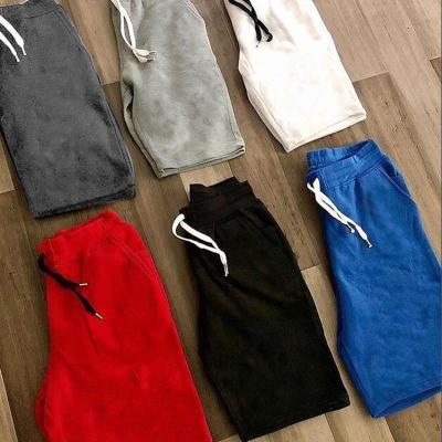 China New QUICK DRY solid color shorts men's summer five-point pants men's fashion casual beach pants foreign trade sports five-point pants for sale