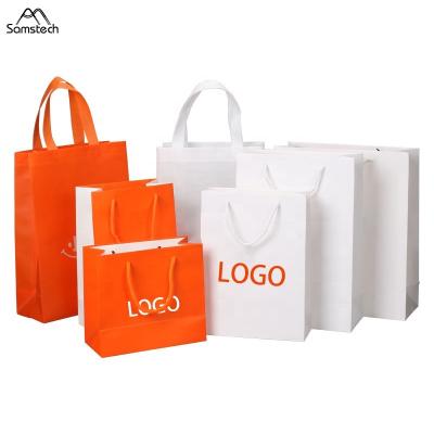 China Disposable Promotional Fancy Printed Packaging Luxury Custom Logo Tote Gift Bags Paper With Handle for sale