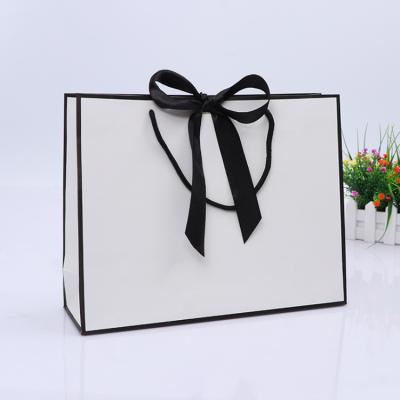 China Hot Custom Disposable High End Custom Gold Foil Die Cut Handle White Logo Paper Gift Bag With Bow Tie Ribbon for sale