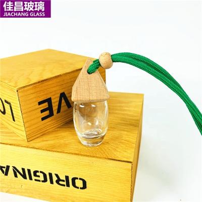 China PERFUME Car Perfume Glass Bottle 10ml Empty Hanging Perfume Bottle Essential Oil Diffuser With Wooden Cover for sale