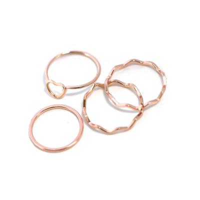 China CLASSIC Women's Jewelry 4 Piece Ring Set Rose Gold Plated Hollow Heart Shaped Wave Metal Ring Set for sale