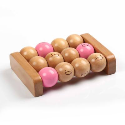 China Wooden Rotating Foot Ball Massager Foot Massager With Cute Faces for sale