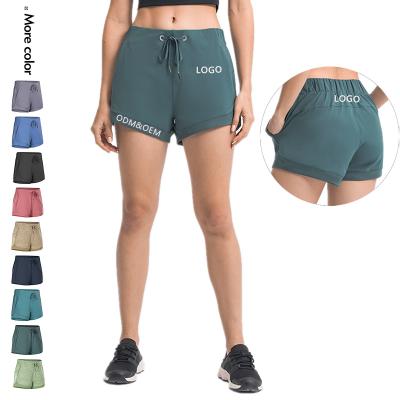 China Xsunwing QUICK DRY Wholesale Women's Running Sports Shorts Sports Active Diaper Elastic Waist Workout Yoga Shorts With Pockets for sale