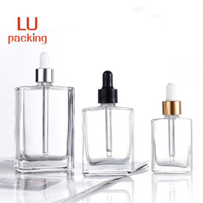 China Personal Care 15ml 30ml 50ml 100ml Square Flat Rectangle Luxury Dropper Glass Bottles With Shiny Gold Silver Collar For Serum for sale