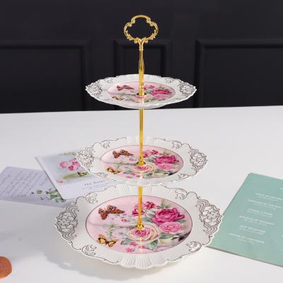 China QYD Viable Porcelain Cupcake Display 3 Tier Ceramic Dishes 2 Layer Snack Wedding Decoration Cake Tray Stand Up Luxury Gold Metal Handle for sale