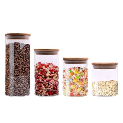 China Wholesale 660mL 900mL Heatable High Quality Borosilicate Wide Mouth Food Storage Round Glass Jars With Bamboo Wooden Lids for sale