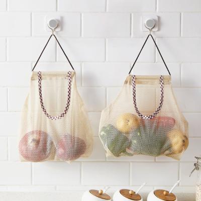 China Creative Universal Folding Mesh Vegetable Bag Storage Kitchen Fruit Wall Hanging Storage Bag for sale