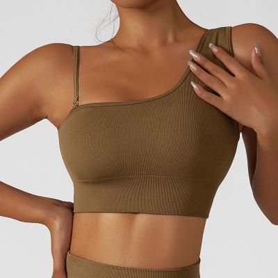 China Women Antibacterial Compression One Shoulder Sports Gym Bra High-Support Upper Lift Up Simple Fitness Yoga Bra Strap Suit Bra for sale