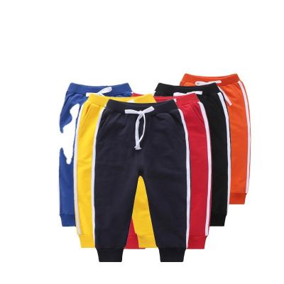 China Anti-wrinkle cotton autumn fashion brand pants three bars kids pants solid color pendant 2022 custom logo for sale