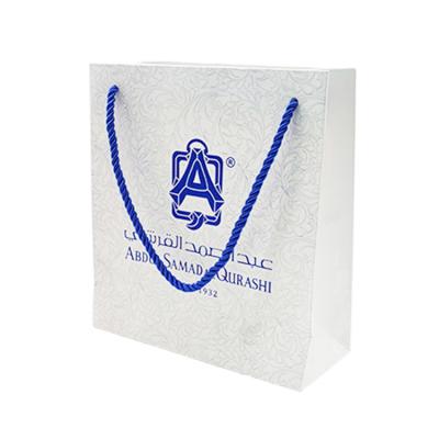 China New Quality Recyclable Blue Logo Hot Foiled Stamping Top Cardboard Matt Paper Bag With Cotton Rope Luxury Customized Handles for sale