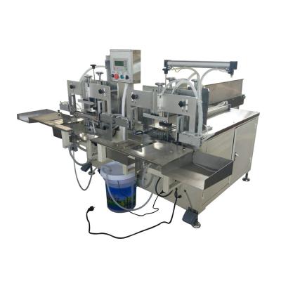 China Manual Easy Operation Napkin Tissue Paper Double Heads Bag Packing Machine for sale