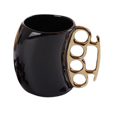 China Viable Creative Ceramic Coffee Milk Handle Ring Mug With Gold Finger Fist Cup Mug White / Ceramic Black for sale