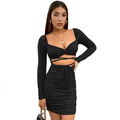 China Anti-wrinkle sexy cut pleated low cut women two piece set European and American cropped long sleeve crossover tops hip skirts for sale