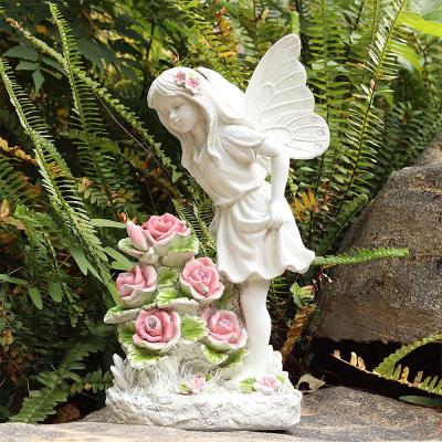 China Europe Garden Angel Fairy Solar Lighted Resin Girl Stand Near Solar Flower Sculpture Lights for sale